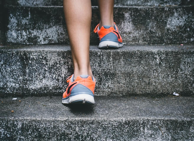 pair of feet jogging up stairs